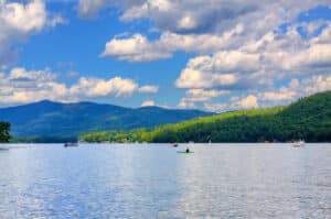 Lake George, New York State. Lake George is located in the southeastern Adirondack State Park and is nicknamed the Queen of American Lakes. It is a long, narrow lake situated at the base of the Adirondack Mountains. HDR (photorealistic) image.